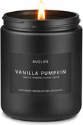 A lit Auelife Vanilla Pumpkin scented candle in a matte black glass jar with a white label, set against a solid white background.